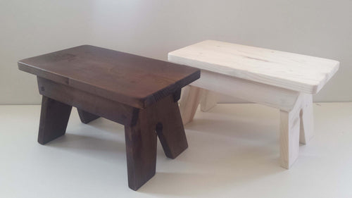 a wooden chair and a table in a room 